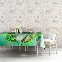Green tablecloth featuring Irish skull, shamrock, and gold coin details on a table set.