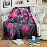 Black and magenta witch skull blanket with hooded woman and roses, draped on couch