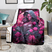Black and magenta witch skull blanket with hooded woman and roses, placed on floor