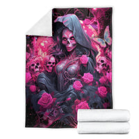 Black and magenta witch skull blanket with hooded woman and roses, shown folded with towels