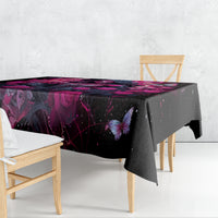 Black tablecloth draped over dining table edge with purple-pink fantasy print and butterfly