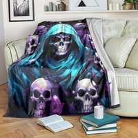 Skull-themed hooded blanket with blue hood and purple skulls, laid over sofa arm