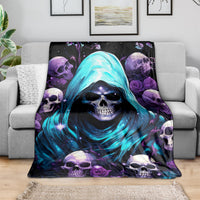 Hooded skull blanket with glowing blue figure and purple skulls, spread on couch