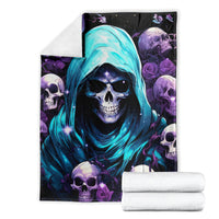 Hooded skull blanket with blue hood art, shown with folded white towels