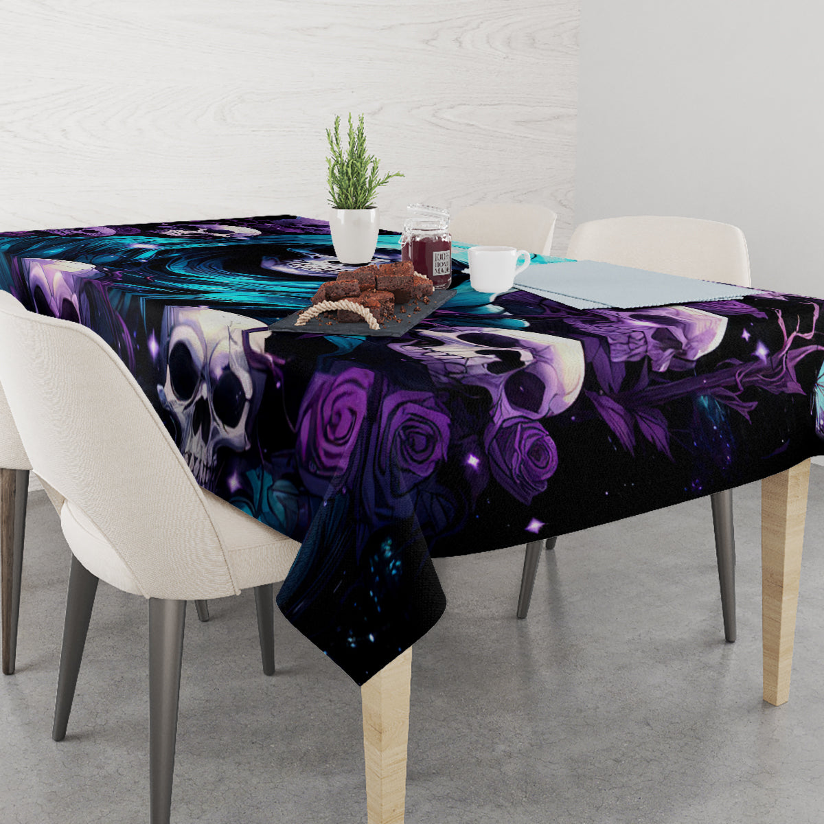 Black skull and rose tablecloth covering a dining table with purple and teal graphics