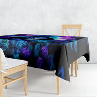 Black tablecloth with blue and purple rose print, draped over table