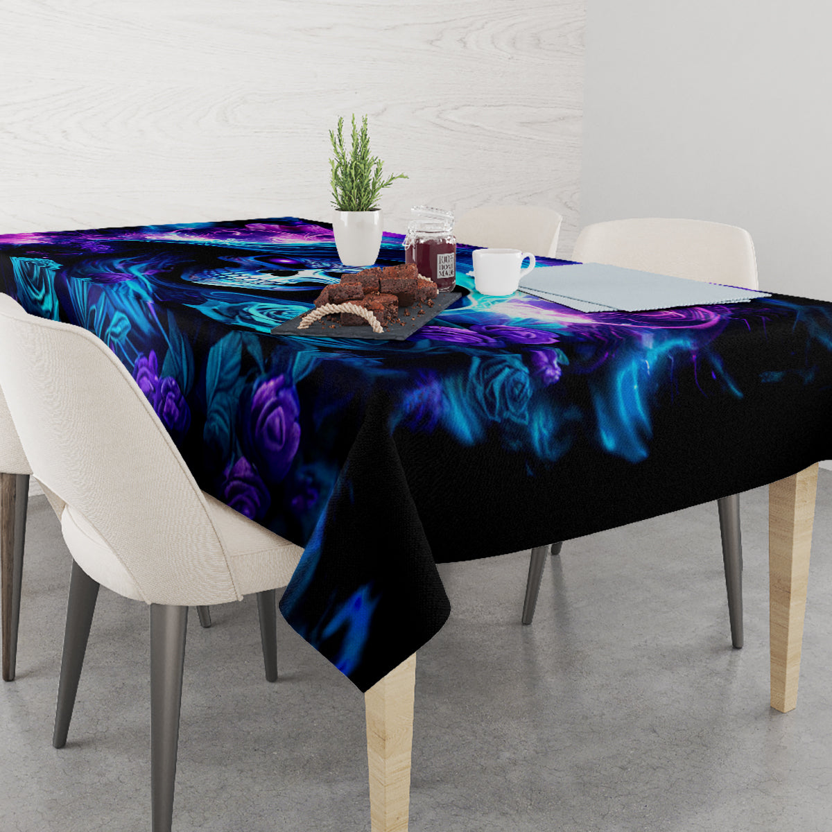 Black tablecloth with blue and purple floral skull design on dining table