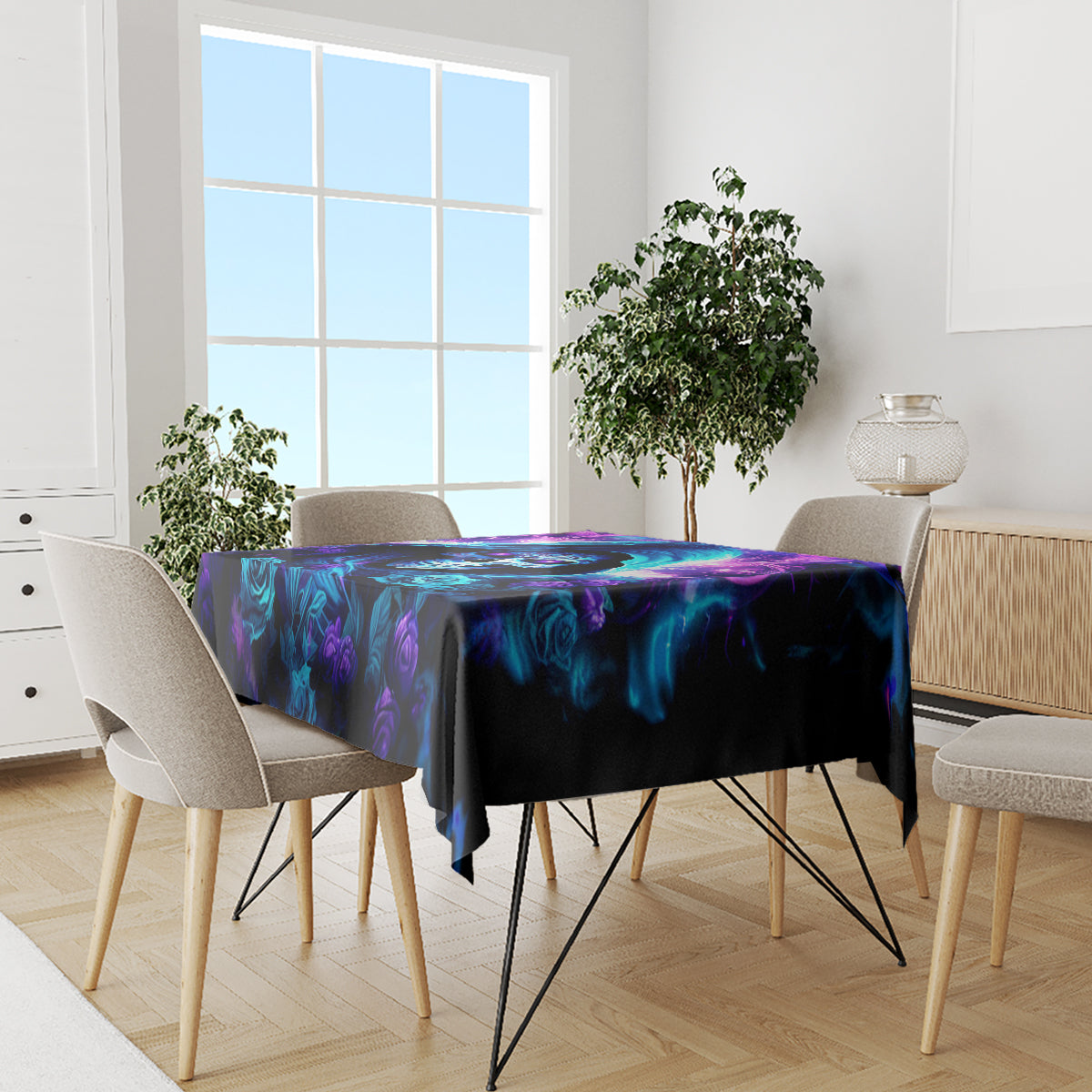 Black tablecloth with blue and purple rose skull artwork on dining table