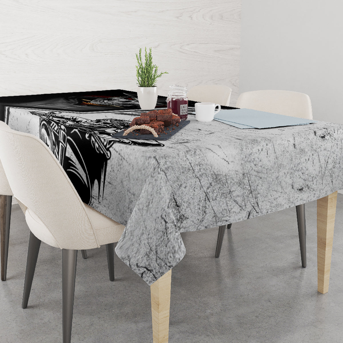 Rectangular tablecloth with black-and-gray motorcycle skull design draped on dining table