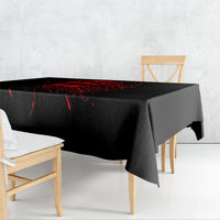 Black Halloween tablecloth with red skull design on dining table, draped