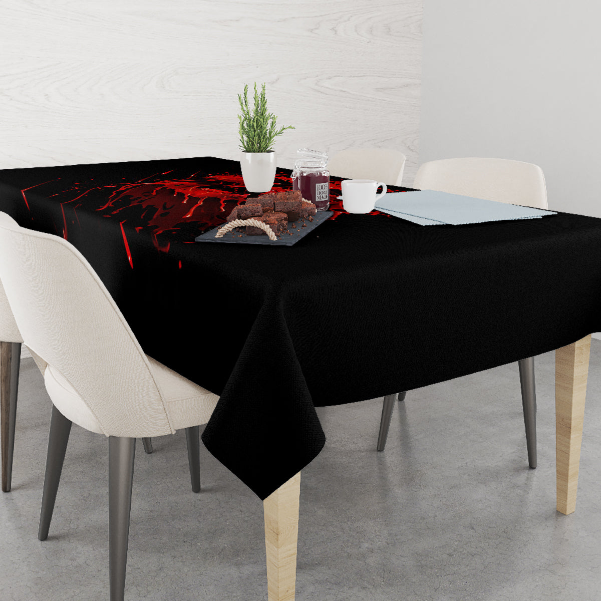 Black tablecloth with red skull and spray pattern, dining table setting