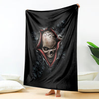 Black skeleton skull graphic blanket with fiery red accents, draped over bed