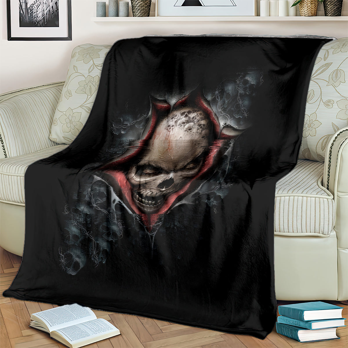 Black skeleton skull graphic blanket with red highlights, folded over a chair