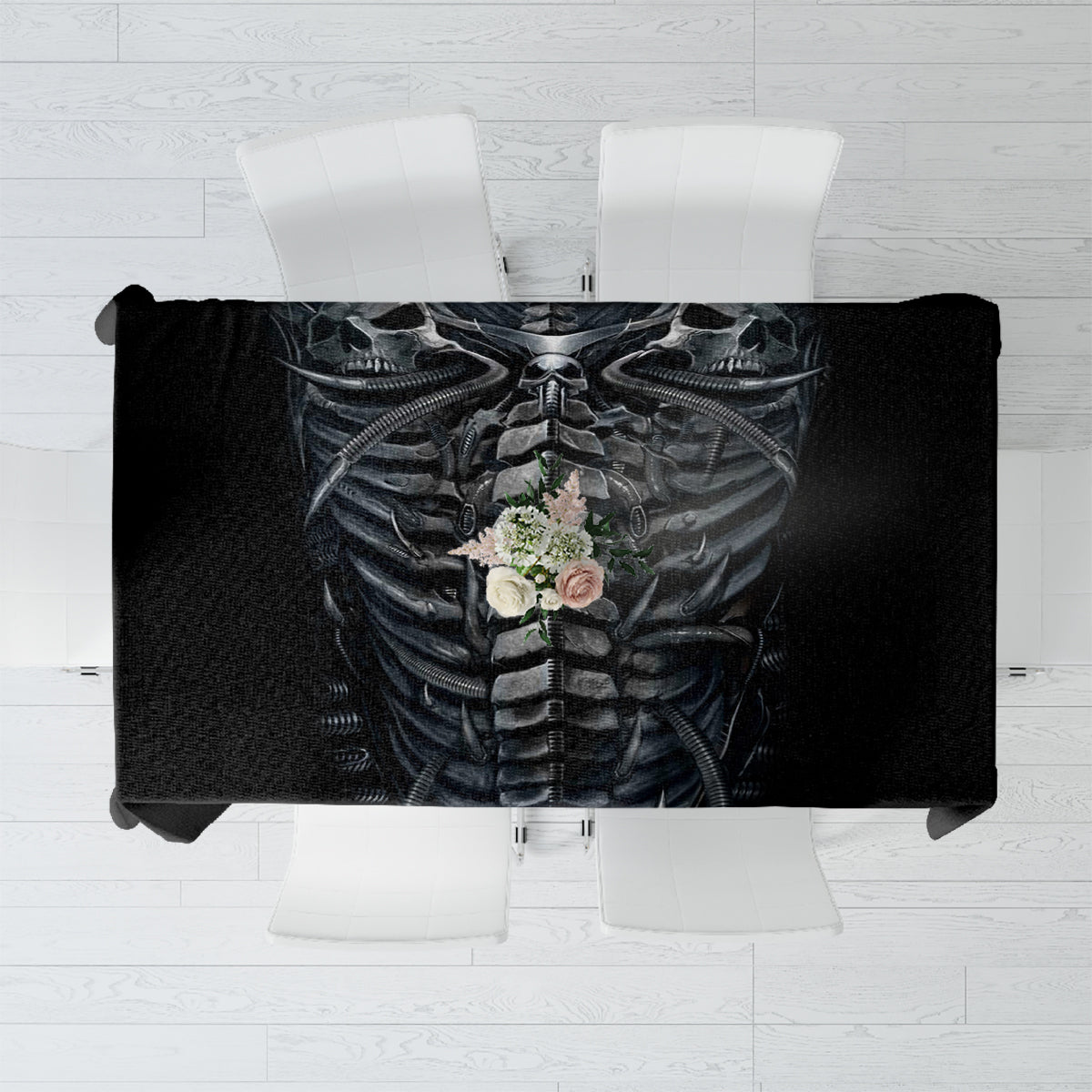 Black tablecloth with skeleton skull print and floral bouquet detail, rectangular overhang.
