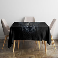 Black tablecloth featuring skeleton skull artwork, smooth top surface with overhanging corners.