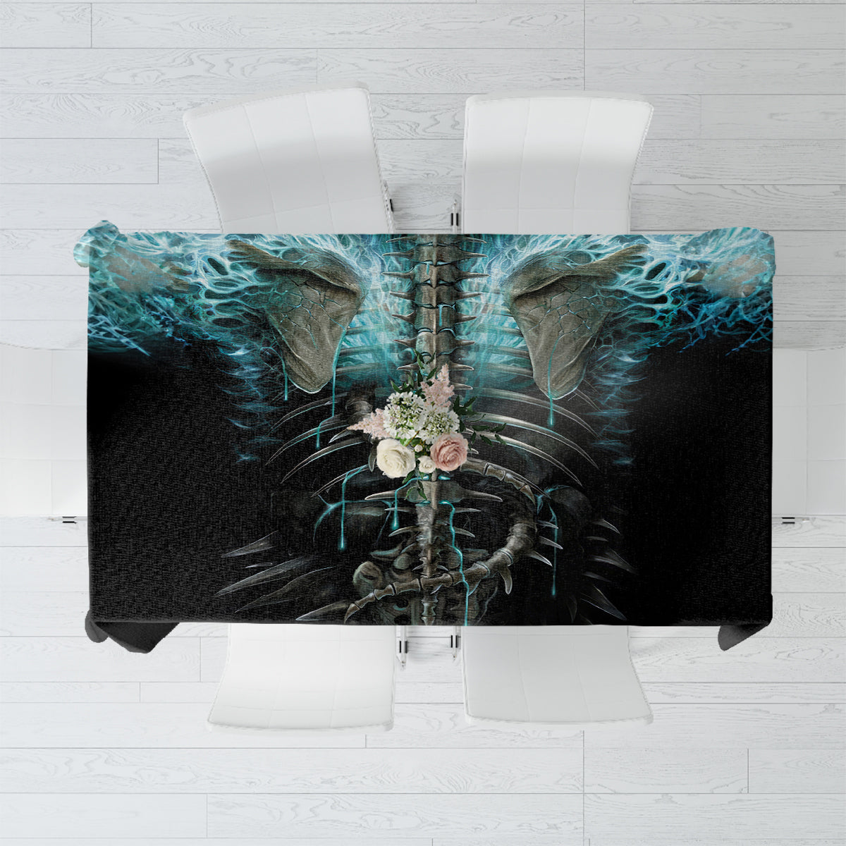 Black tablecloth top view with centered blue flame skull and skeleton artwork