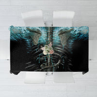 Black tablecloth top view with centered blue flame skull and skeleton artwork