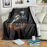 Black fantasy blanket with glowing skull rider design, draped on a striped couch