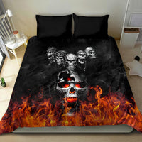 Black flaming skull bedding set featuring skull faces above orange fire flames on duvet