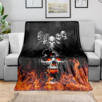 Black skull and flame graphic blanket spread on a sofa
