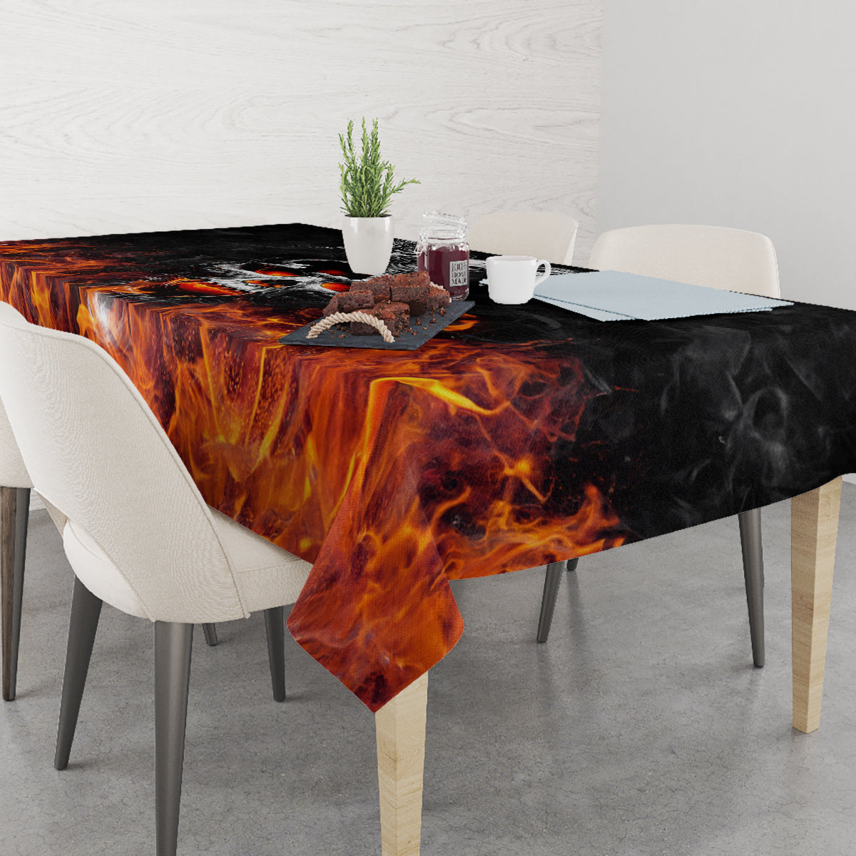 Black rectangular tablecloth with orange flame pattern, drapes over table edges