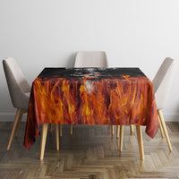 Orange-and-black flame patterned tablecloth on dining table with four chairs