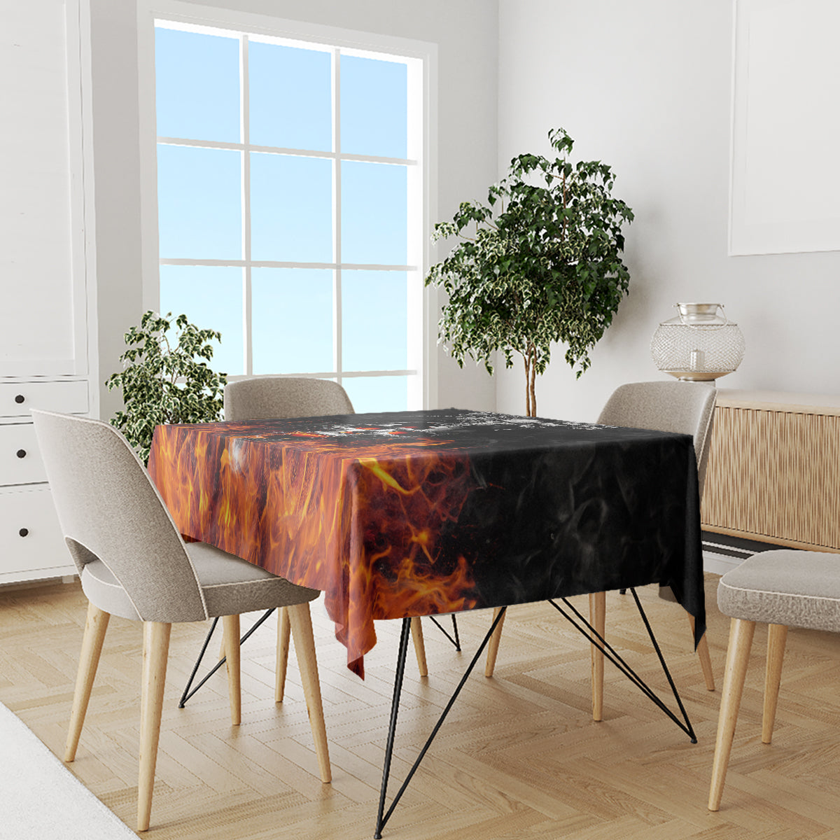 Flame-patterned tablecloth covering dining table, orange fire design across top