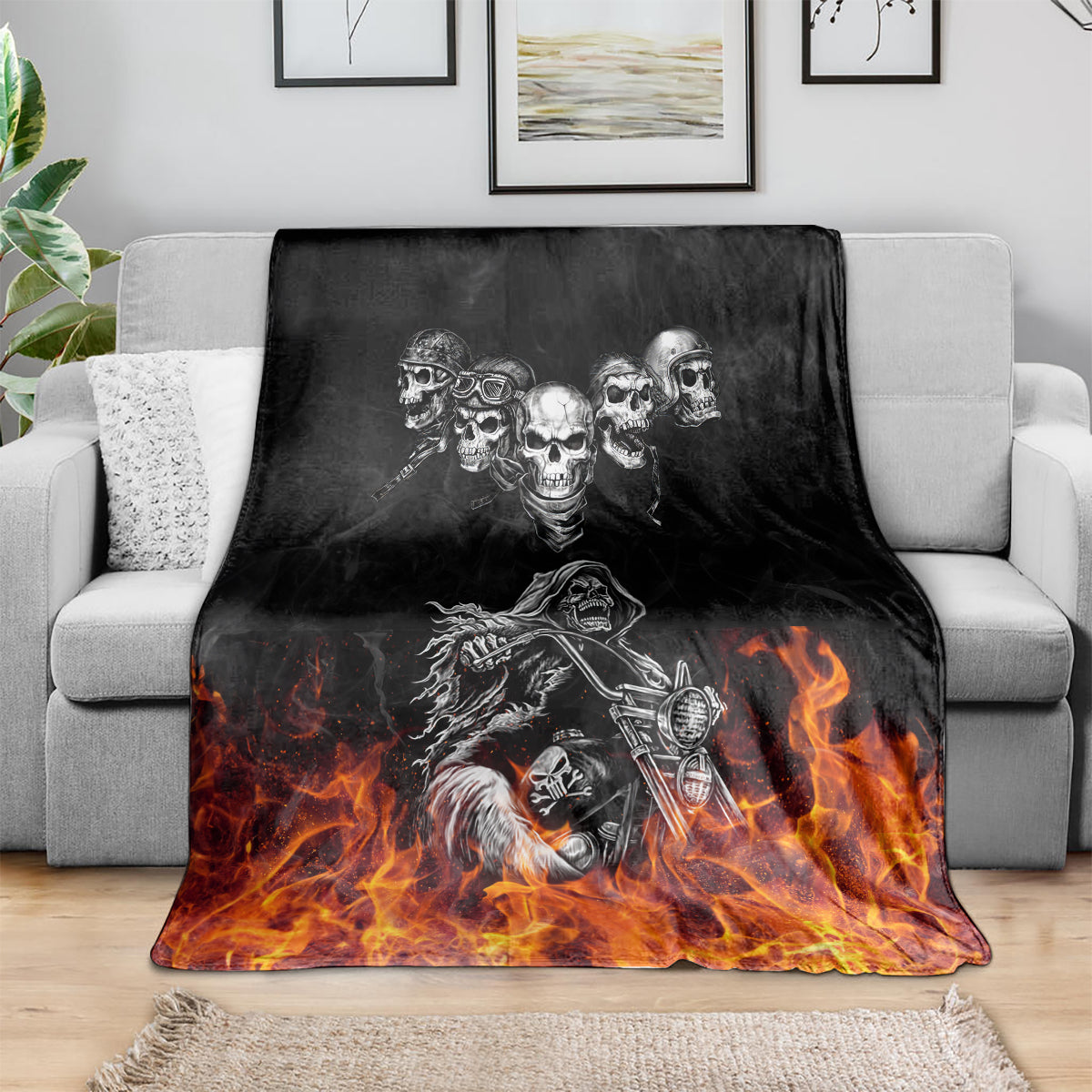 Black skull and motorcycle blanket, spread on a sofa with orange flames