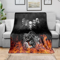 Black skull and motorcycle blanket, spread on a sofa with orange flames