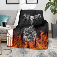 Black skull and motorcycle blanket with flames, laid over a couch seat