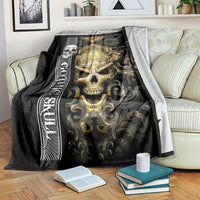 Black gothic skull blanket on bed with gold skull, crown ornament, and dark filigree