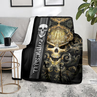 Black gothic skull blanket with gold skull and vertical rune stripe, casually draped