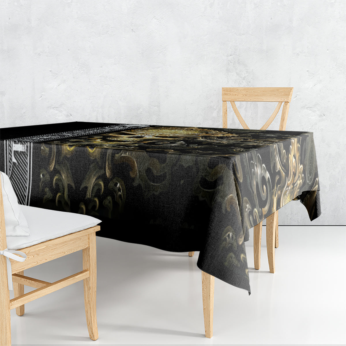 Black tablecloth with gold swirling filigree gothic design, draped over table