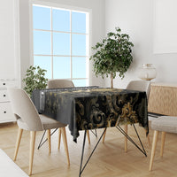 Black gothic tablecloth with gold filigree design, draped over dining table