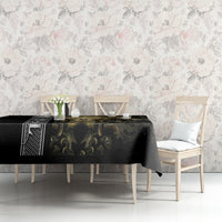 Black gothic tablecloth with gold filigree skull motif, neatly spread on table