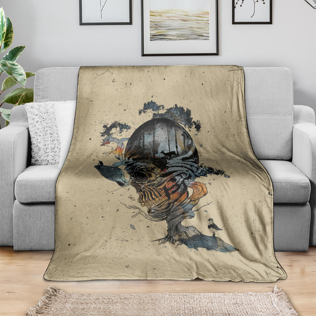 Beige skull graphic blanket, draped over gray sofa back and seat