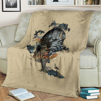 Beige skull graphic throw blanket, spread over light-colored couch