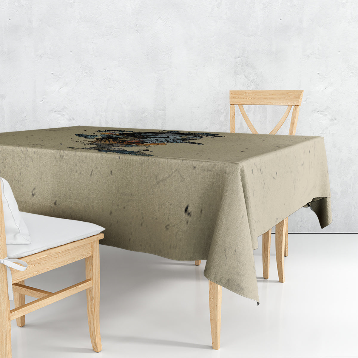 Beige tablecloth draped over dining table, skull artwork printed across the top