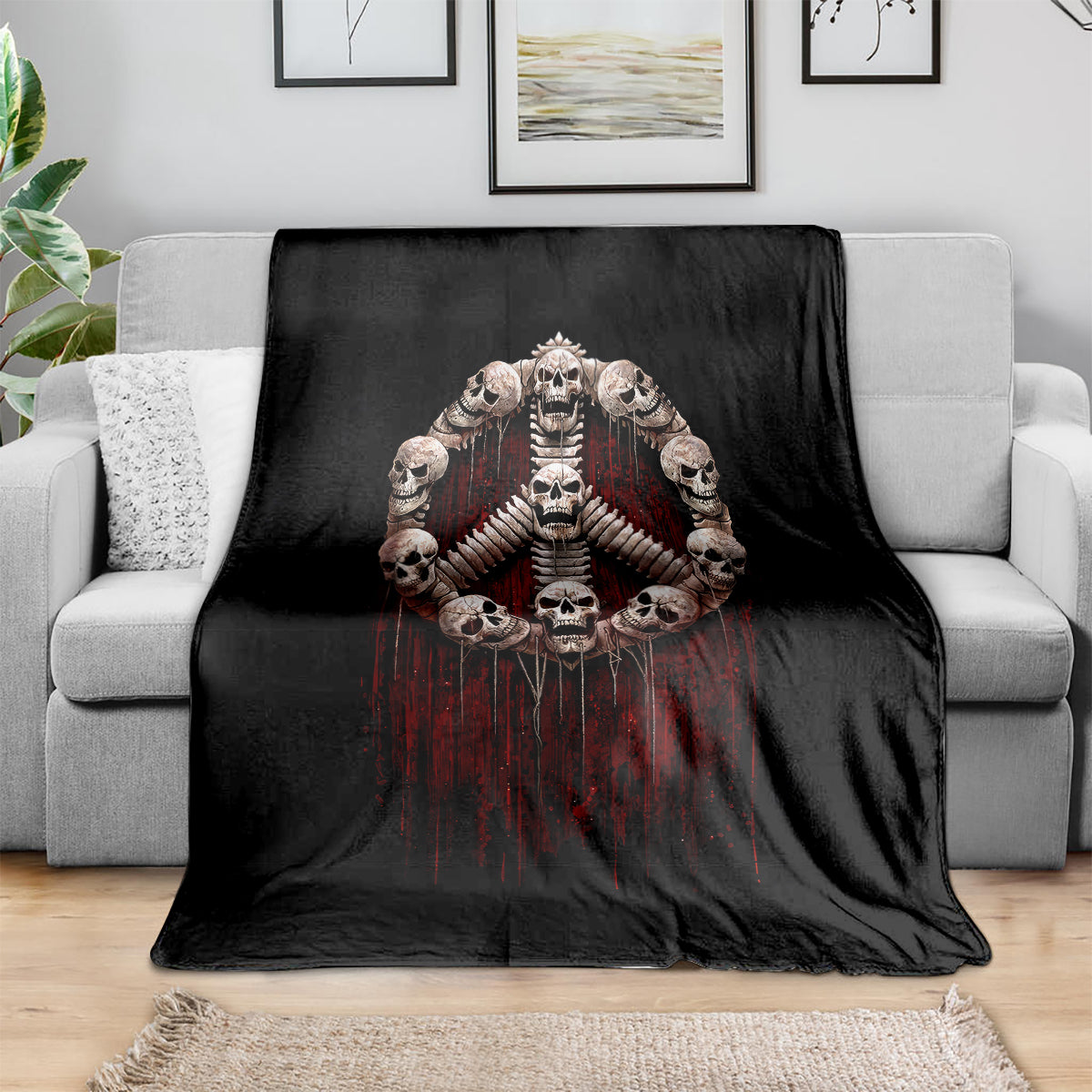 Black throw blanket with skull angel skeleton hands graphic and dark red drips