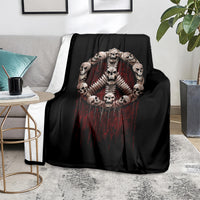 Black skull angel skeleton throw blanket draped on couch with red dripping center