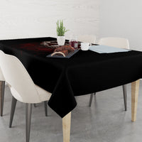 Black skull angel tablecloth draped over dining table, corner overhang visible