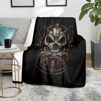 Black mechanical skull blanket over gray couch, large face graphic centered