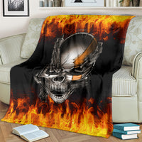 Black skull and chain throw blanket with blazing flames, draped on light couch