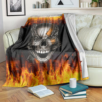 Black skull and chain blanket with flames, spread over sofa with books