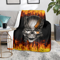 Black skull and chain throw blanket with fiery flames, laid on living room rug
