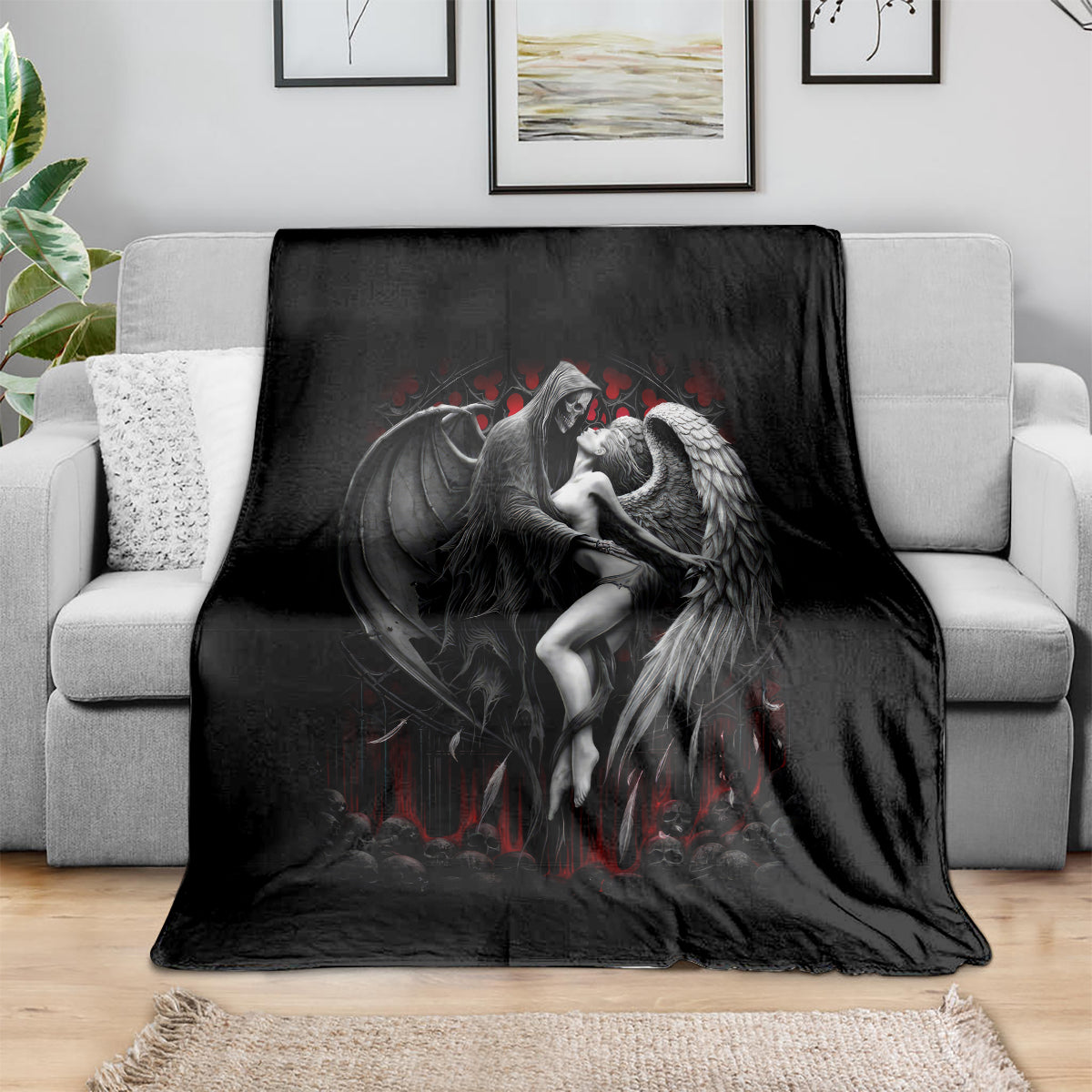 Black throw blanket featuring winged angel couple graphic with red details