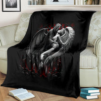 Black angel wing graphic blanket with red accents, draped over a couch