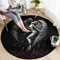 Black round death angel rug showing gray wings and white figure reaching from center