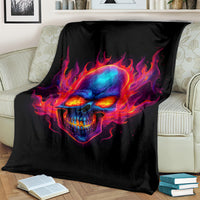 Black skull flame blanket over couch, close view of neon-blue skull and orange-red flames