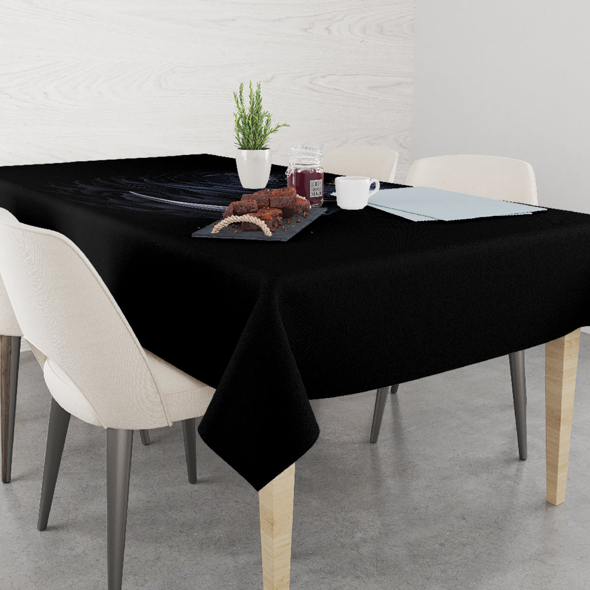 Black skull and reaper tablecloth draped on a dining table, with floral accent print